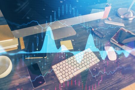 Double exposure of forex graph and work space with computer. Concept of international online...