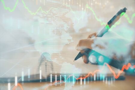 Forex graph on hand taking notes background. Concept of research. Multi exposure