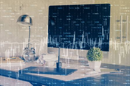 Financial graph colorful drawing and table with computer on background. Double exposure. Concept of international markets.の写真素材