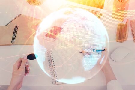 International business hologram over hands taking notes background. Concept of success. Multi exposureの写真素材