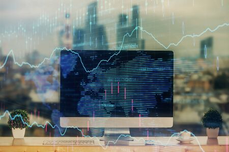 Stock market graph on background with desk and personal computer. Multi exposure. Concept of...