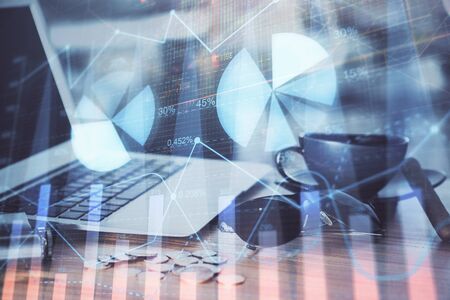 Financial market graph hologram and personal computer on background. Multi exposure. Concept of forex.の写真素材