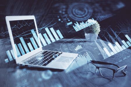 Forex market graph hologram and personal computer on background. Multi exposure. Concept of investment.の写真素材