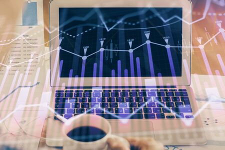 Stock market graph and table with computer background. Double exposure. Concept of financial analysis.の写真素材