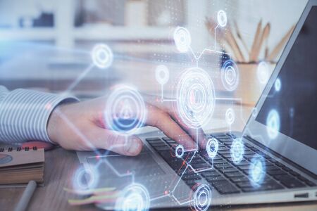 A man working on Laptop with technology theme drawing. Concept of big data. Double exposure.