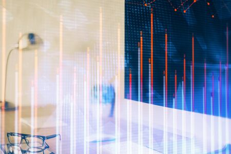 Forex graph hologram on table with computer background. Multi exposure. Concept of financial...