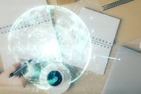International business hologram over hands taking notes background. Concept of success. Multi exposureの写真素材