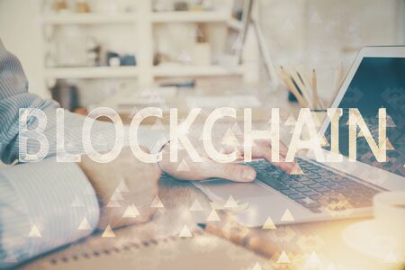Blockchain theme hud with man working on computer on background. Concept of crypto chain. Double exposure.の写真素材