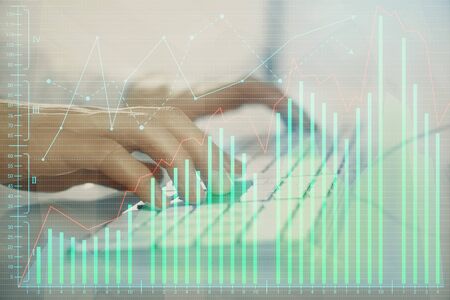 Forex graph with businessman working on computer in office on background. Concept of hardworking. Closeup. Multi exposure.の写真素材