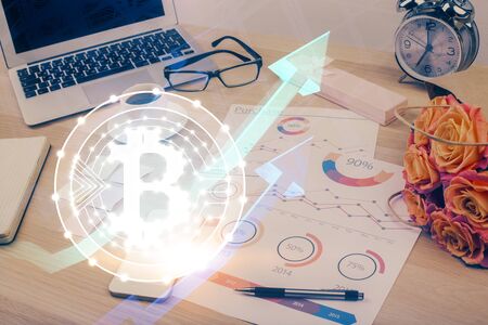 Double exposure of blockchain and crypto economy theme hologram and table with computer background. Concept of bitcoin cryptocurrency.の写真素材