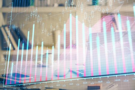 Forex market graph hologram and personal computer on background. Multi exposure. Concept of investment.の写真素材