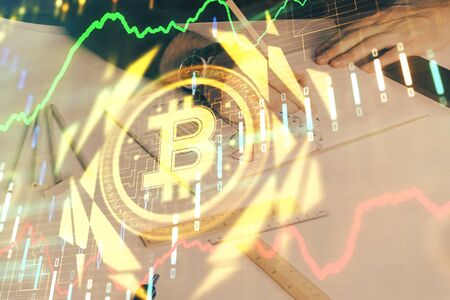 Mans hands working with notes background. Cryptocurrency and finance concept.の写真素材