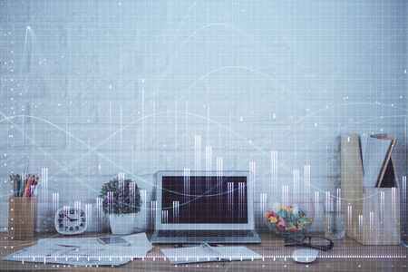 Financial chart drawing and table with computer on background. Double exposure. Concept of international markets.の写真素材