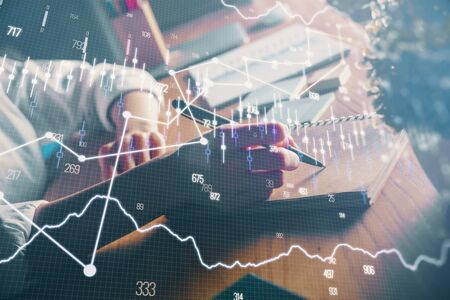 Financial forex charts displayed on womans hand taking notes background. Concept of research. Double...
