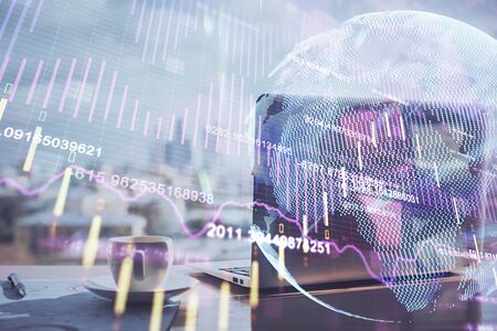 Double exposure of chart and financial info and work space with computer background. Concept of international online trading.の写真素材