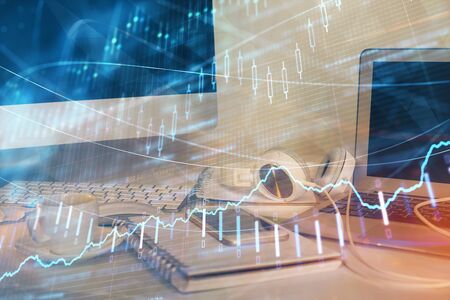 Financial market graph hologram and personal computer on background. Multi exposure. Concept of...