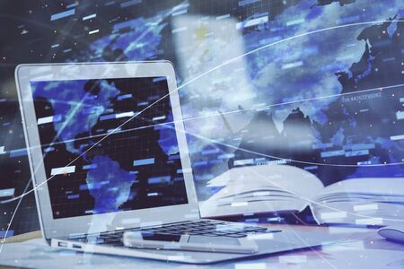 Double exposure of table with computer on background and data theme hologram. Data technology concept.の写真素材