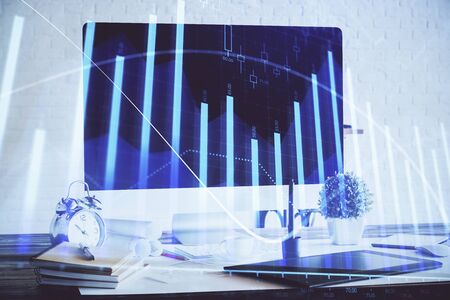 Forex Chart hologram on table with computer background. Double exposure. Concept of financial markets.の写真素材