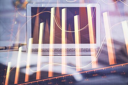 Forex market chart hologram and personal computer background. Double exposure. Concept of investment.の写真素材