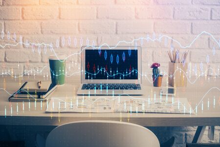 Financial graph colorful drawing and table with computer on background. Multi exposure. Concept of international markets.の写真素材