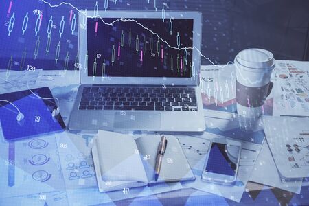 Financial graph colorful drawing and table with computer on background. Multi exposure. Concept of international markets.の写真素材