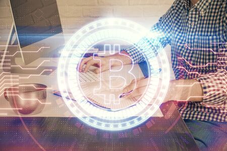 Blockchain theme hud with man working on computer on background. Concept of crypto chain. Double exposure.の写真素材