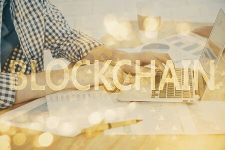 Blockchain theme hud with man working on computer on background. Concept of crypto chain. Double exposure.の写真素材