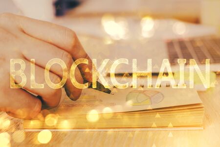Mans hands working with notes background. Cryptocurrency and finance concept.の写真素材