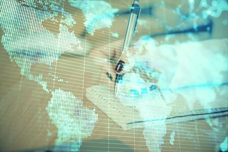 International business hologram over hands taking notes background. Concept of success. Multi exposureの写真素材