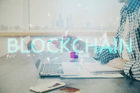 Blockchain theme hud with man working on computer on background. Concept of crypto chain. Double...