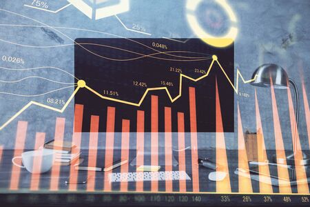Financial market graph hologram and personal computer on background. Multi exposure. Concept of forex.の写真素材
