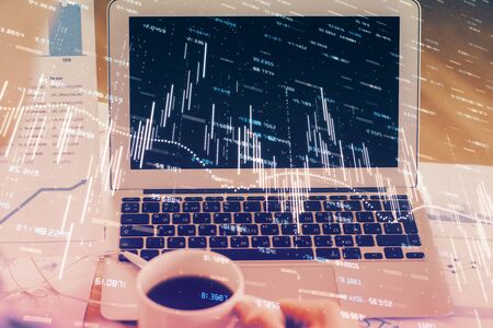 Stock market graph and table with computer background. Multi exposure. Concept of financial analysis.の写真素材