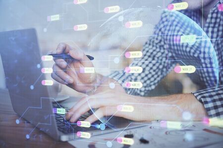 Businessman with computer background with technology theme hologram. Concept of hightech. Multi exposure.の写真素材