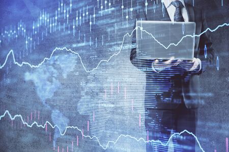 Forex graph with businessman working on laptop on background. Concept of hardworking. Multi...