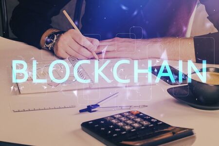 Mans hands working with notes background. Cryptocurrency and finance concept.