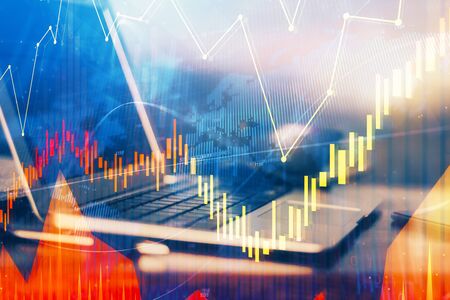 Double exposure of chart and financial info and work space with computer background. Concept of...