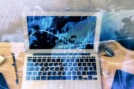 Double exposure of forex graph and work space with computer. Concept of international online trading.の写真素材
