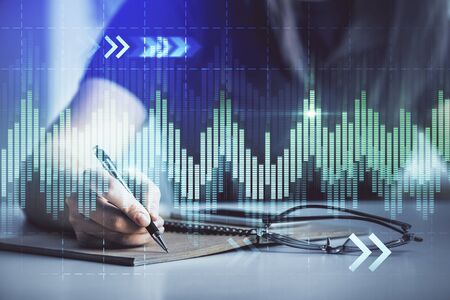 Multi exposure of womans hands making notes with forex graph hologram. Concept of technical...