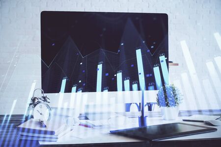 Forex Chart hologram on table with computer background. Double exposure. Concept of financial markets.の写真素材