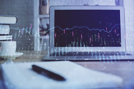 Stock market graph and table with computer background. Multi exposure. Concept of financial analysis.の写真素材