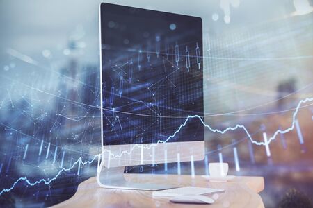 Forex market graph hologram and personal computer on background. Double exposure. Concept of...