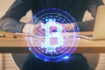 Man's hands working with notes background. Cryptocurrency and finance concept. Double exposure.の写真素材