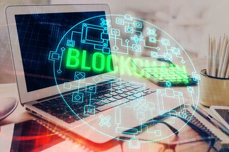 Double exposure of blockchain and crypto economy theme hologram and table with computer background. Concept of bitcoin cryptocurrency.の写真素材