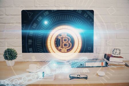 Double exposure of blockchain and crypto economy theme hologram and table with computer background. Concept of bitcoin cryptocurrency.の写真素材