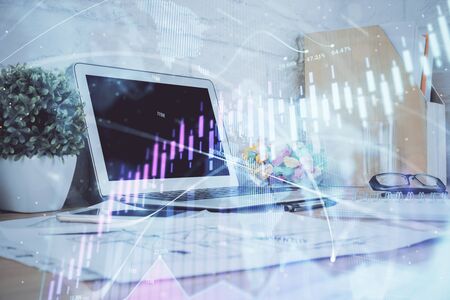 Stock market graph and table with computer background. Double exposure. Concept of financial analysis.の写真素材