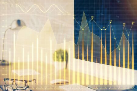 Stock market graph and table with computer background. Double exposure. Concept of financial analysis.の写真素材