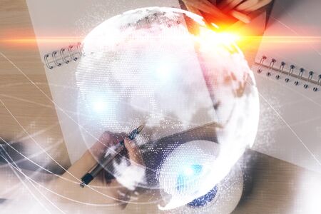 International business hologram over hands taking notes background. Concept of success. Multi...