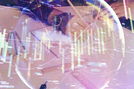 Double exposure of hands and notepad with business icons.の写真素材