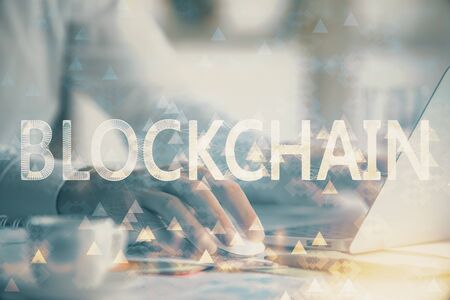 Blockchain theme hologram with man working on computer on background. Concept of crypto chain. Double exposure.の写真素材
