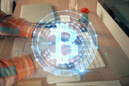 Blockchain theme hud with man working on computer on background. Concept of crypto chain. Double exposure.の写真素材